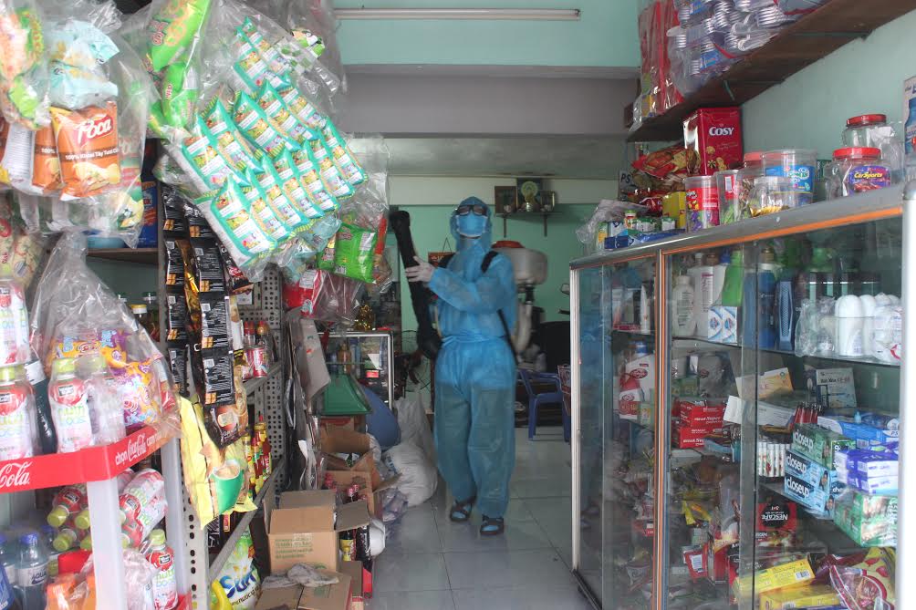 Spraying chemical to kill mosquitoes and larvae.