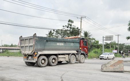 Những chiếc xe tải “khủng” chạy liên tục, cày nát mặt đường.