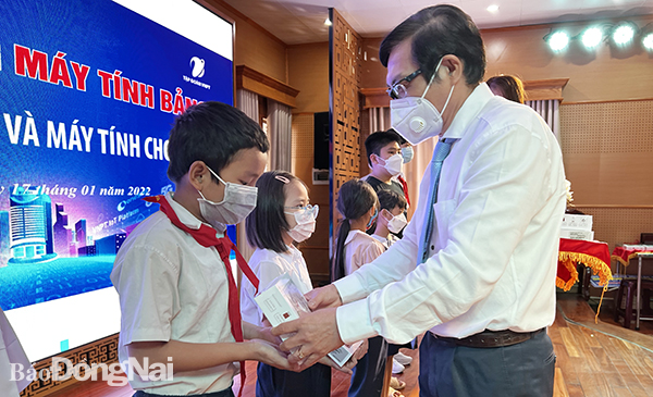 Chairwoman Nguyen Thi Cat Tien of Xuan Loc district People’s Committee hands over smart phones to poor students.