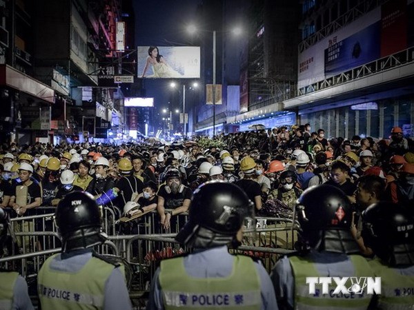 Cảnh sát được triển khai ngăn chặn người biểu tình chủ trương chiếm lại Mongkok ngày 19/10. (Ảnh: AFP/TTXVN)