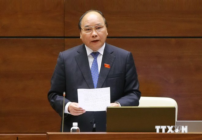 Phó Thủ tướng Chính phủ Nguyễn Xuân Phúc trả lời chất vấn của đại biểu Quốc hội. (Ảnh: TTXVN)