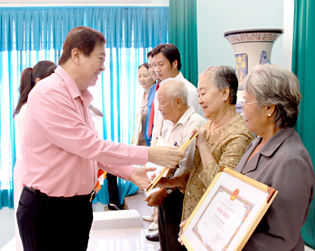 Chủ tịch Hội Từ thiện tỉnh Đỗ Hữu Tài trao tặng bằng khen của UBND tỉnh cho các cá nhân, tập thể có thành tích xuất sắc trong công tác từ thiện. Ảnh: H.Dung