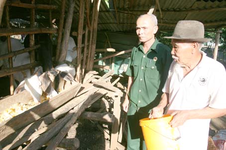 Chủ tịch Hội Cựu chiến binh xã Trà Cổ (huyện Tân Phú) Nguyễn Văn Sửa (trái) thăm  mô hình chăn nuôi của một hội viên được nhận vốn từ quỹ hội để phát triển kinh tế.