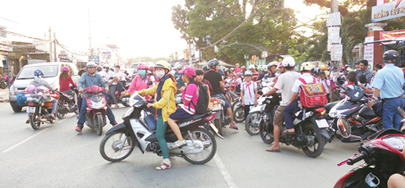 Phụ huynh dừng, đậu xe tràn lan trước cổng Trường tiểu học Phước Thiền (huyện Nhơn Trạch). Ảnh: T.Hải