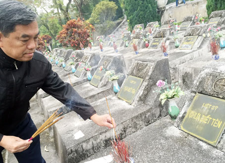 Chủ tịch Ủy ban MTTQ tỉnh Huỳnh Văn Tới thắp hương viếng liệt sĩ tại Nghĩa trang liệt sĩ quốc gia Vị Xuyên. Ảnh: H.LAM