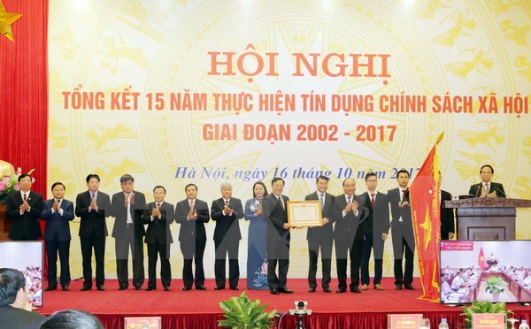 Thủ tướng Chính phủ Nguyễn Xuân Phúc trao Huân chương Lao động Hạng Nhất cho Ngân hàng Chính sách Xã hội. (Ảnh: Trần Việt/TTXVN)