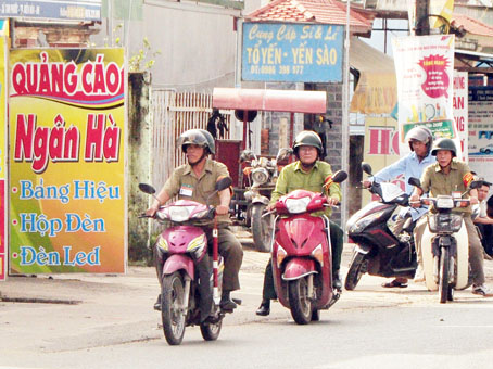 Ông Trần Cao Định (điều khiển xe máy thứ 2 từ trái qua) đi tuần tra cùng Tổ trưởng Tổ An ninh tự quản Chi hội 4, ấp Long Đức 1.