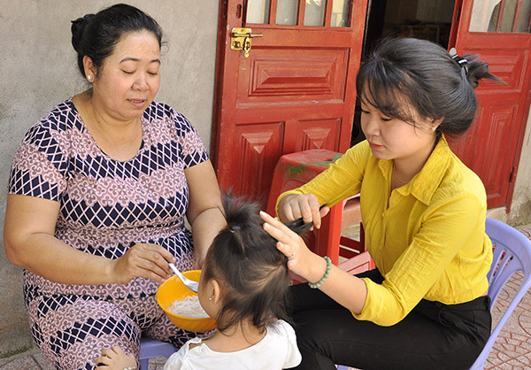 2 mẹ con bà Thạch Thị Tha chăm sóc cho một đứa trẻ nuôi tại chùa Thanh Lương (phường Bửu Hòa, TP.Biên Hòa). Ảnh: D.NGỌC