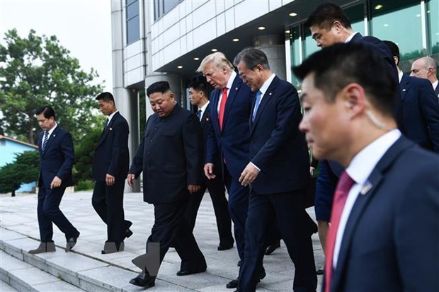Nhà lãnh đạo Triều Tiên Kim Jong-un (thứ 3, trái) và Tổng thống Mỹ Donald Trump (giữa) sau cuộc gặp ở làng đình chiến Panmunjom tại Khu phi quân sự (DMZ) chiều 30-6-2019. (Ảnh: AFP/TTXVN)