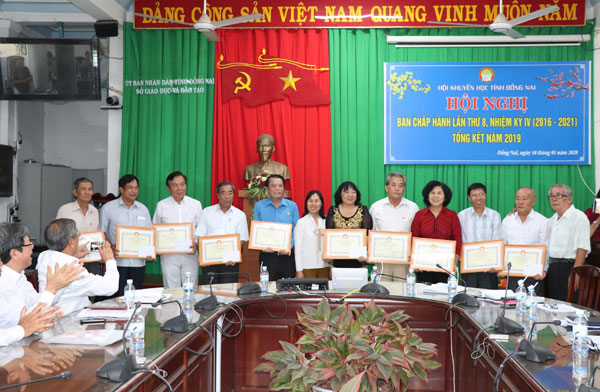 Chủ tịch Hội khuyến học tỉnh Nguyễn Trùng Phương (bìa phải) trao giấy khen cho các đơn vị đạt thành tích cao trong năm 2019.