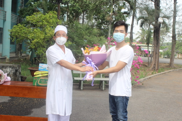 Phó giám đốc Sở Y tế Lê Quang Trung tặng hoa chúc mừng anh V.V.T. được xuất viện