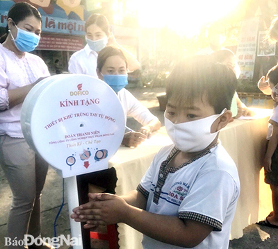 Trẻ tại Trường mầm non Hoa Sen, phường Tân Hiệp (TP.Biên Hòa) rửa tay bằng máy tự phun dung dịch sát khuẩn do doanh nghiệp tài trợ