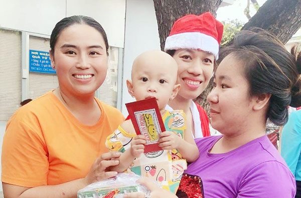 Chị Nguyễn Thị Tuyết Hạnh (bìa trái) tặng quà cho trẻ em có hoàn cảnh khó khăn (Ảnh: Nhân vật cung cấp)