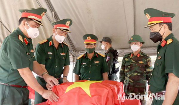 Thiếu tướng Nguyễn Trường Thắng (thứ hai từ trái qua) và Ban Chỉ đạo 515 Quân khu 7, tỉnh Đồng Nai bên hài cốt liệt sĩ vừa được tìm thấy tại xã Phước An (H.Nhơn Trạch). Ảnh: Nguyệt Hà