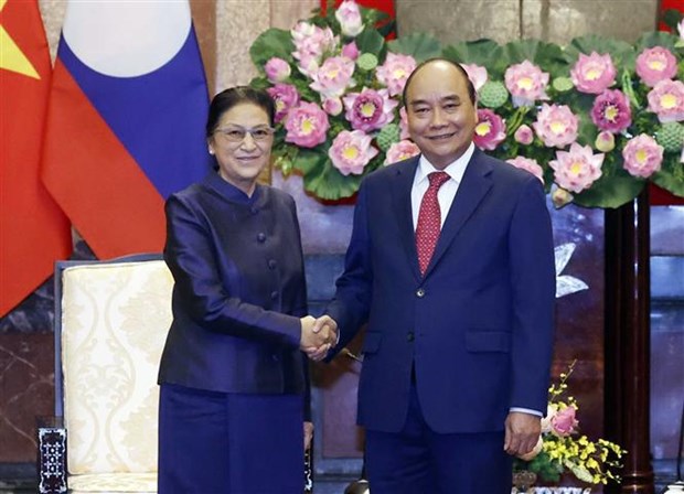 President Nguyen Xuan Phuc (R) shakes hands with Vice President of Laos Pany Yathotou