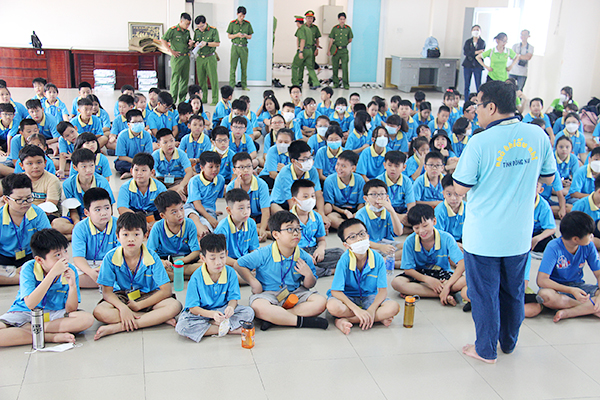  Các em học sinh nghe phổ biến kế hoạch cho chương trình Một ngày làm chiến sĩ công an nhân dân