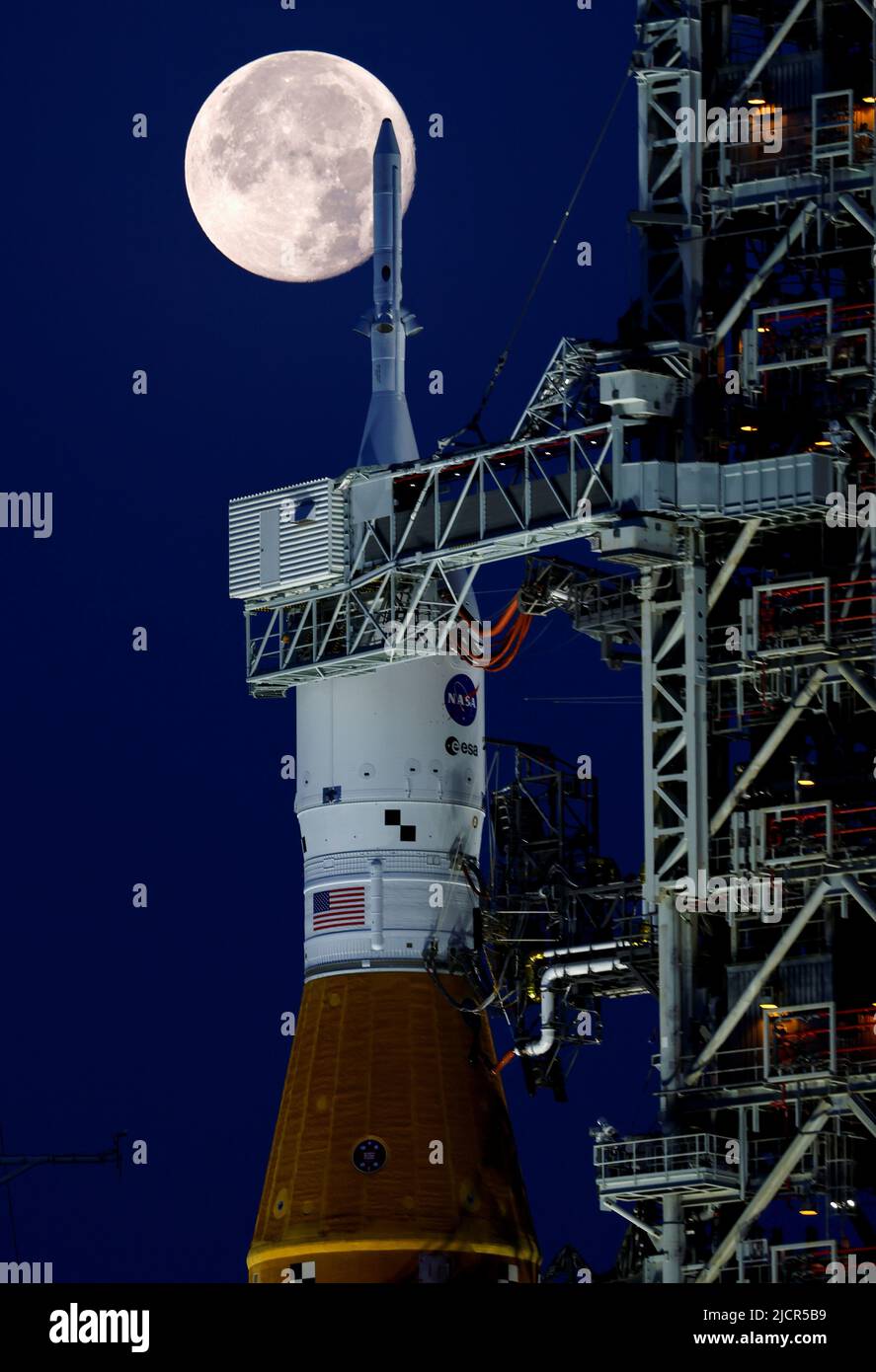 A full moon, known as the "Strawberry Moon" is shown with NASA’s next-generation moon rocket, the Space Launch System (SLS) Artemis 1, at the Kennedy Space Center in Cape Canaveral, Florida, U.S. June 15, 2022.